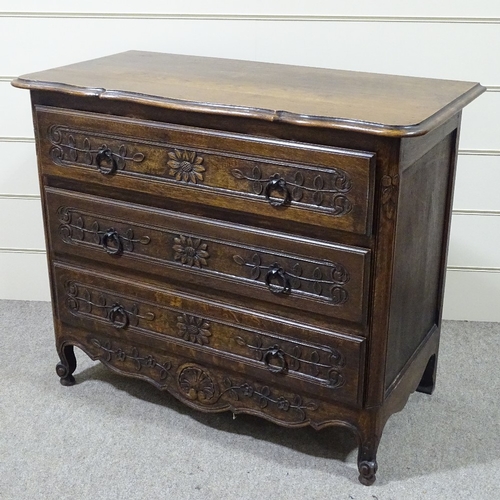 318 - A 19th century French oak 3-drawer commode with relief carved drawer fronts, width 3'7