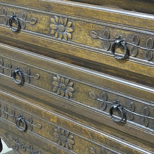 318 - A 19th century French oak 3-drawer commode with relief carved drawer fronts, width 3'7