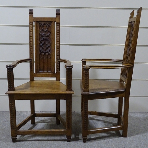 320 - A pair of Gothic style oak hall chairs, with relief carved tracery panelled backs