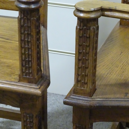 320 - A pair of Gothic style oak hall chairs, with relief carved tracery panelled backs