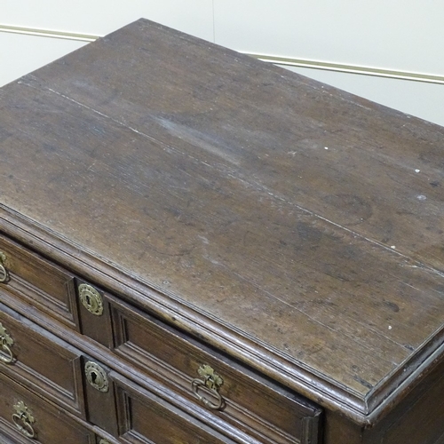 321 - An 18th century joined oak chest of 4 long drawers, with panelled drawer fronts and bracket feet, wi... 