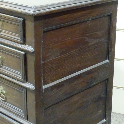 321 - An 18th century joined oak chest of 4 long drawers, with panelled drawer fronts and bracket feet, wi... 