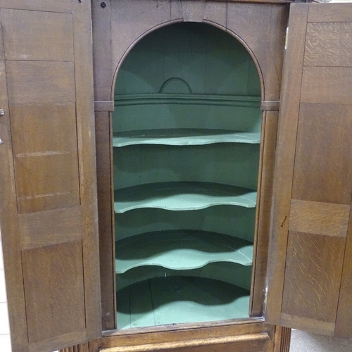 326 - An 18th century floor standing panelled oak corner cupboard, with fluted corners