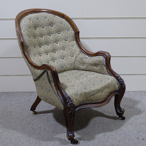 338 - A Victorian carved and shaped mahogany-framed fireside armchair