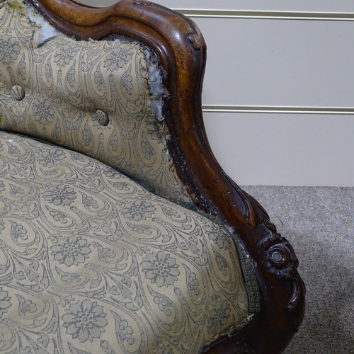 338 - A Victorian carved and shaped mahogany-framed fireside armchair