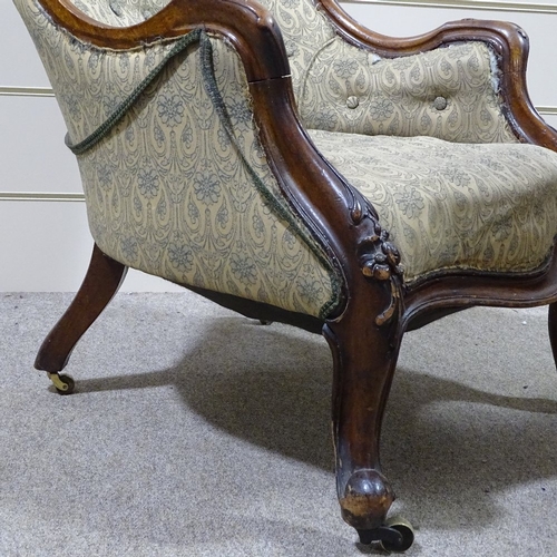 338 - A Victorian carved and shaped mahogany-framed fireside armchair