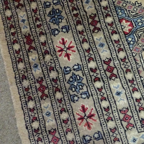 343 - A large cream ground Tekke wool rug, 310cm x 215cm