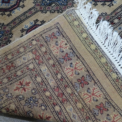 343 - A large cream ground Tekke wool rug, 310cm x 215cm