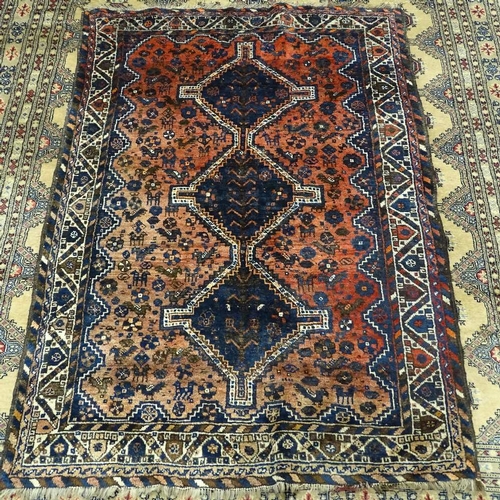 345 - A Persian red ground Shiraz wool rug, bird and geometric decoration, 177cm x 127cm