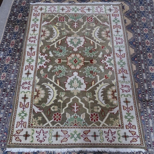 346 - An Afghan cream ground Ziegler wool rug, floral decoration, 202cm x 138cm