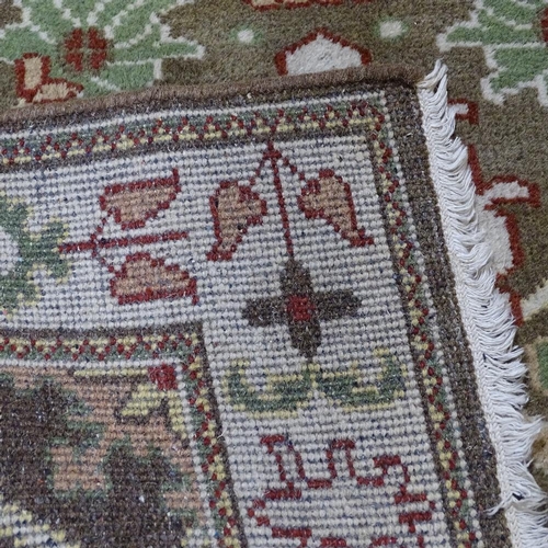 346 - An Afghan cream ground Ziegler wool rug, floral decoration, 202cm x 138cm