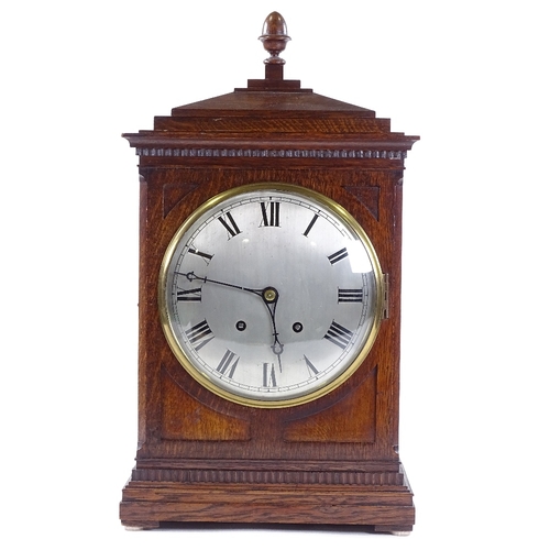 432 - An oak-cased 8-day mantel clock, circa 1900, carved case with silvered dial and striking movement, h... 