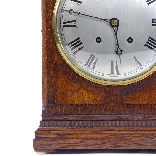 432 - An oak-cased 8-day mantel clock, circa 1900, carved case with silvered dial and striking movement, h... 