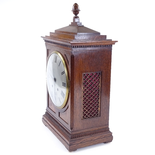 432 - An oak-cased 8-day mantel clock, circa 1900, carved case with silvered dial and striking movement, h... 