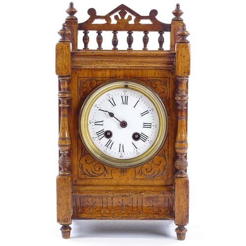 439 - A Victorian carved oak-cased mantel clock, 8-day movement striking on a bell, height 32cm