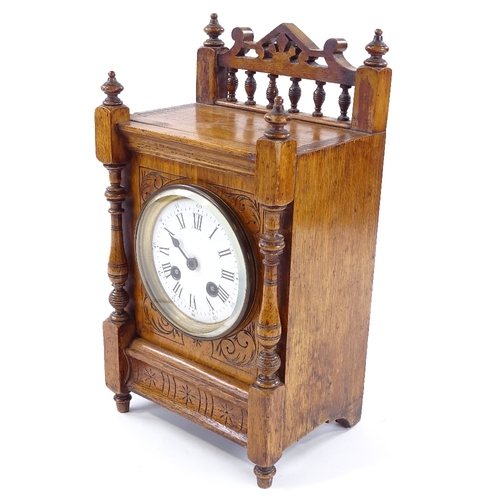 439 - A Victorian carved oak-cased mantel clock, 8-day movement striking on a bell, height 32cm