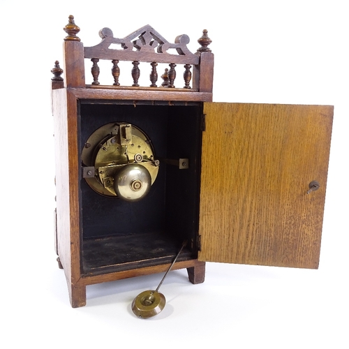 439 - A Victorian carved oak-cased mantel clock, 8-day movement striking on a bell, height 32cm