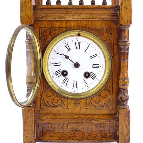 439 - A Victorian carved oak-cased mantel clock, 8-day movement striking on a bell, height 32cm