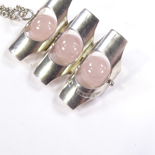 552 - A modernist Finnish sterling silver and rose quartz pendant necklace, stylised form with polished st... 