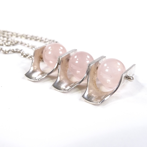 552 - A modernist Finnish sterling silver and rose quartz pendant necklace, stylised form with polished st... 