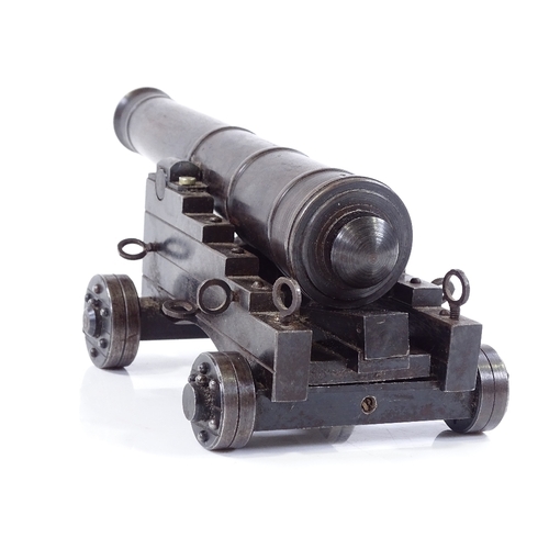 213 - A scratch-built metal model field cannon on metal carriage base, overall length 19cm