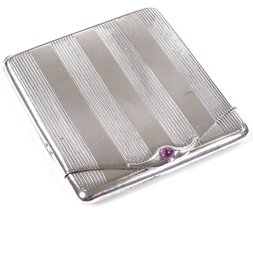 650 - CARTIER - an Art Deco French silver matchbox case, with cabochon ruby thumbpiece, engine turned deco... 