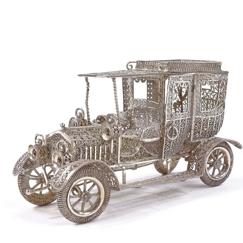 652 - A Maltese unmarked silver filigree Veteran car model, rotating wheels and hinged cab doors, length 1... 