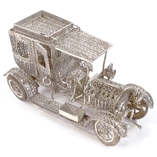 652 - A Maltese unmarked silver filigree Veteran car model, rotating wheels and hinged cab doors, length 1... 