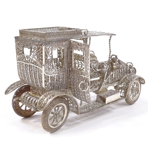 652 - A Maltese unmarked silver filigree Veteran car model, rotating wheels and hinged cab doors, length 1... 