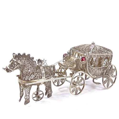 653 - A Maltese unmarked silver filigree horse-drawn carriage model, rotating wheels and stone set lantern... 