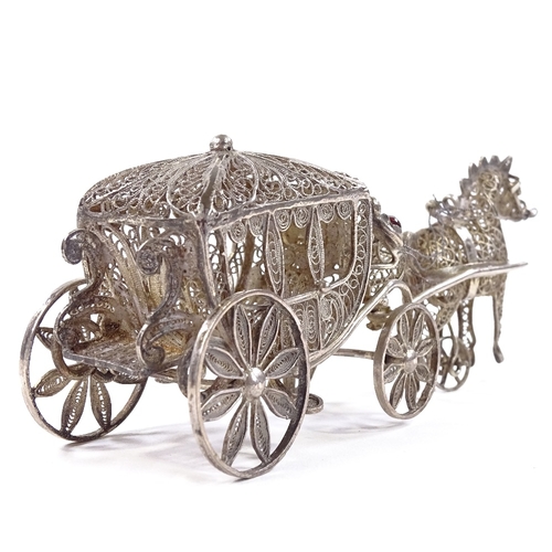 653 - A Maltese unmarked silver filigree horse-drawn carriage model, rotating wheels and stone set lantern... 