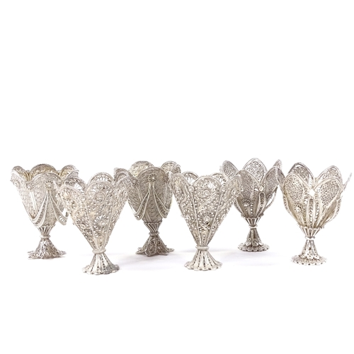 654 - A set of 6 Maltese unmarked silver filigree egg cups, two of each design, with pierced and woven dec... 