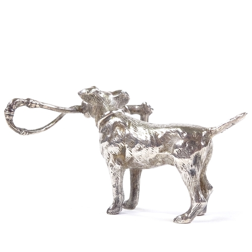 655 - An Edwardian Continental novelty miniature cast-silver model hunting pointer dog holding a riding cr... 