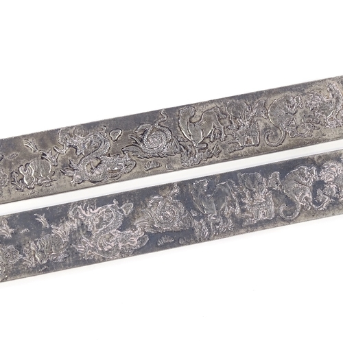 669 - A pair of Chinese export silver rectangular scroll weights, depicting relief 12 Chinese zodiac anima... 