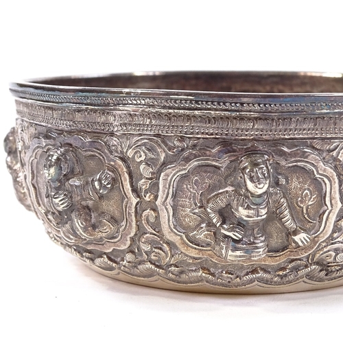 675 - A small Burmese unmarked white metal Thabeik bowl, high relief figural and lotus decoration with eng... 