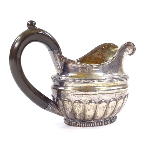 680 - A 19th century Russian silver cream jug, of half fluted form with gadrooned border and a gilt interi... 