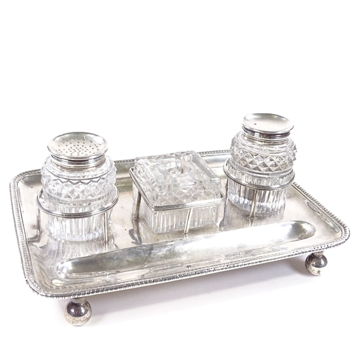 681 - A George III rectangular silver desk stand, double pen tray with cut-glass silver-mounted ink and bl... 