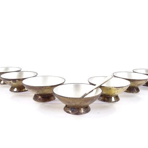 700 - A set of 7 Volmer Bahner Danish vermeil silver and white enamel salt bowls, and a matching spoon, ma... 