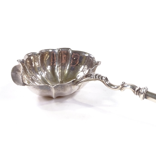 711 - A George II silver toddy ladle, with scalloped bowl, original engraved initials and twisted whale bo... 