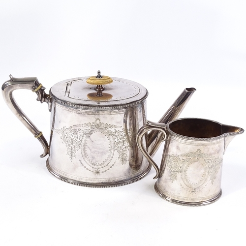 722 - An Elkington & Co silver plated oval teapot and cream jug, ivory insulators with floral engraved dec... 