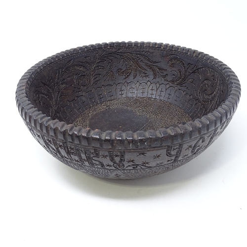 251 - A Russian carved and stained wood bowl, with band of Cyrillic text to the frieze and central engrave... 