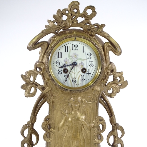 444 - A French Art Nouveau gilded spelter-cased mantel clock, ornate stylised case with relief moulded fem... 