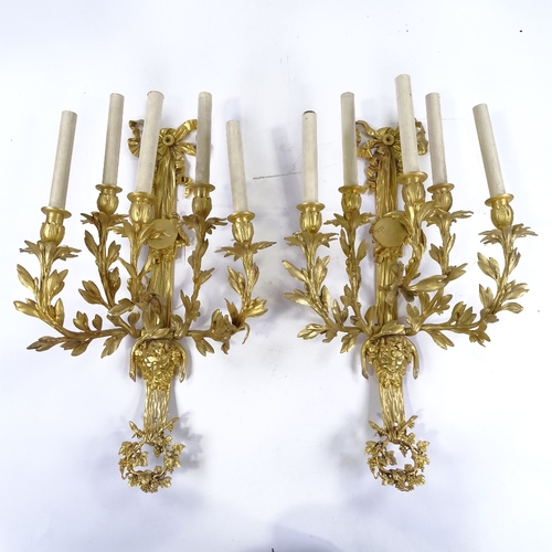 69 - A pair of gilt-bronze 5-branch wall light fittings, decorated with Pan masks, probably circa mid-20t... 