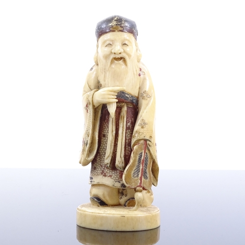 76 - A Japanese carved and painted ivory okimono depicting a Sage, late 19th/early 20th century, signed u... 