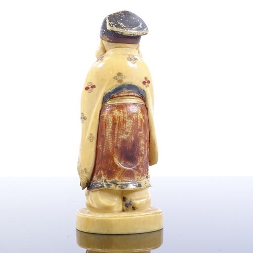 76 - A Japanese carved and painted ivory okimono depicting a Sage, late 19th/early 20th century, signed u... 