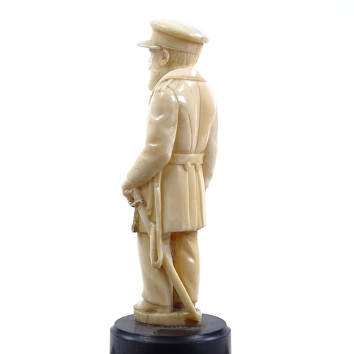 77 - A carved ivory figure of a man in military uniform, unsigned, on turned ebony base, overall height 1... 