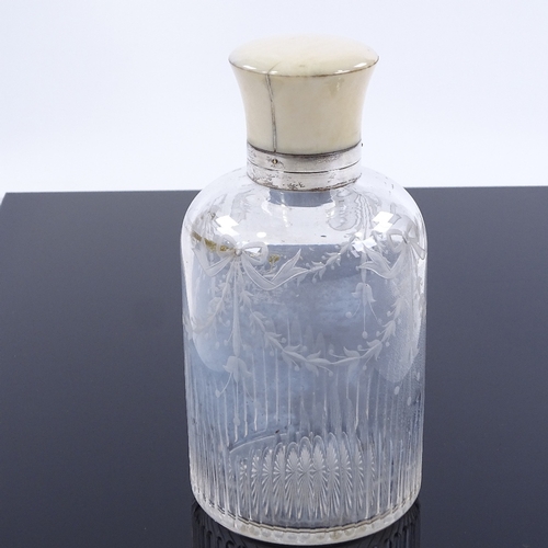 83 - A cut-glass perfume bottle with ivory-mounted silver screw top and etched floral swags, hallmarks Lo... 