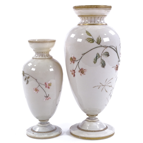 88 - A graduated pair of Victorian milk glass vases, with hand painted designs of exotic birds and flower... 