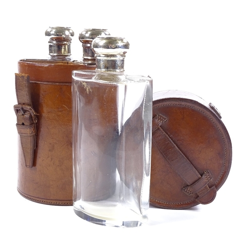 90 - A set of 3 cut-glass silver-topped spirit bottles in original cylindrical leather case, hallmarks Lo... 