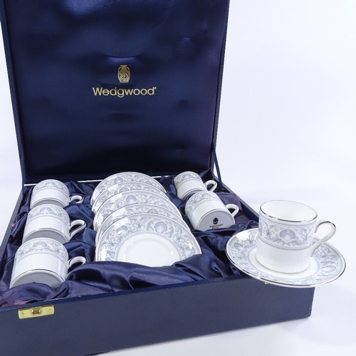 92 - A Wedgwood Dolphins 6 place bone china coffee service, dolphin and shell decoration with silvered ri... 